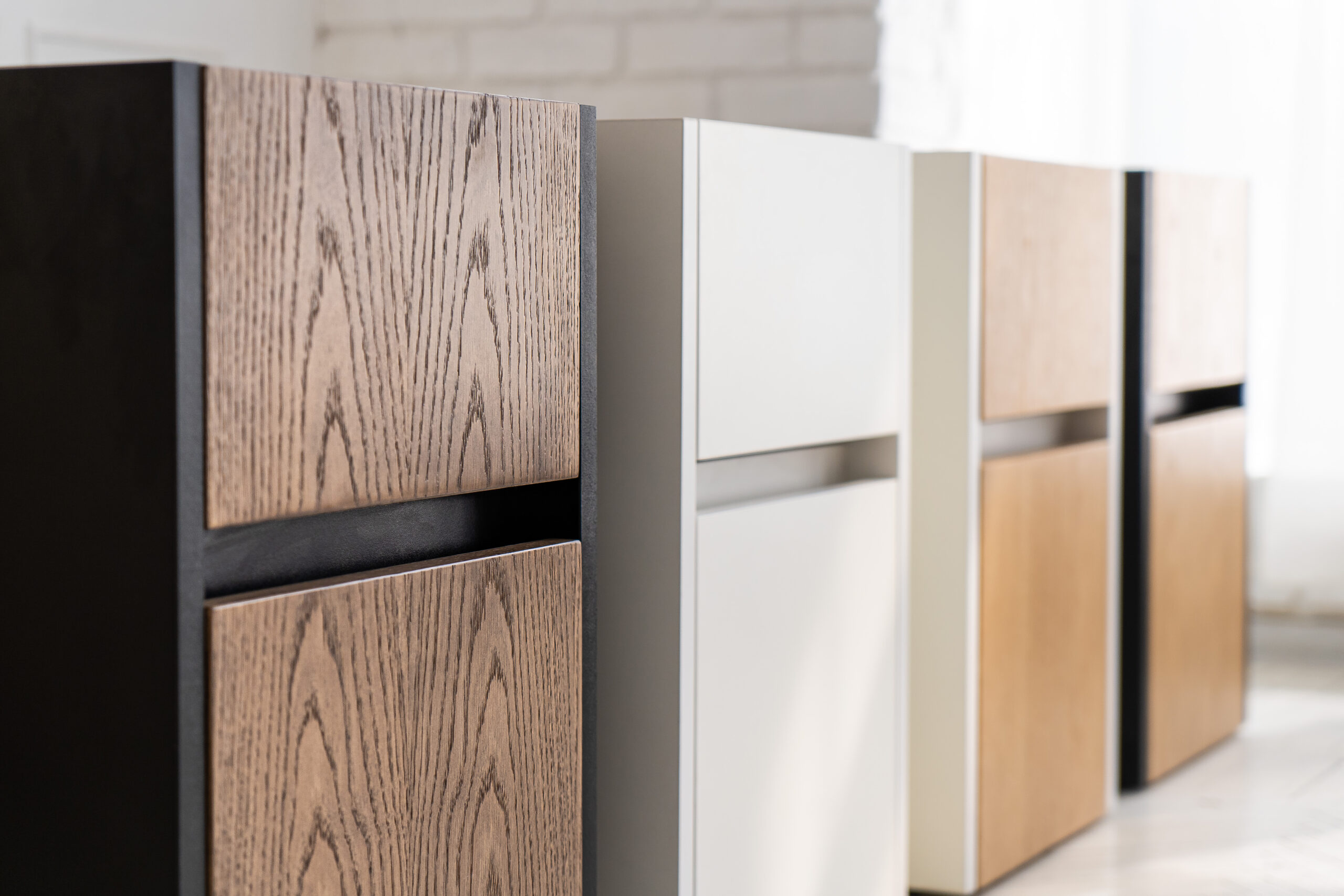 A row of cabinet drawers with laminate finish in various patterns
